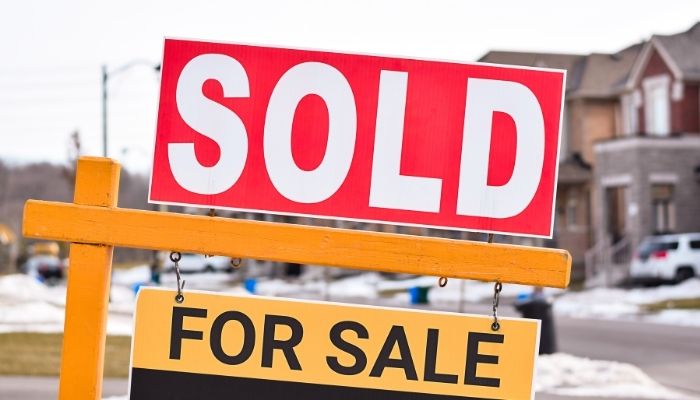 Toronto housing market shift — GTA homes with for sale and sold signs showing active listings.