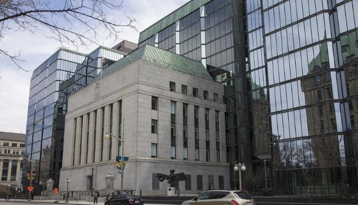 Homeowner reviewing mortgage documents after Bank of Canada interest rate cut