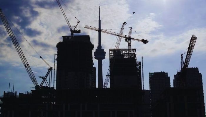 Toronto real estate market skyline showing condos and new construction cranes in downtown Toronto.